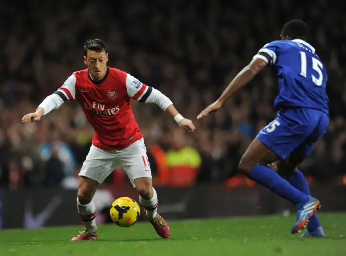 Framed Print : Mesut Ozil Clashes with Sylvain Distin: Arsenal vs Everton, Premier League 2013-14