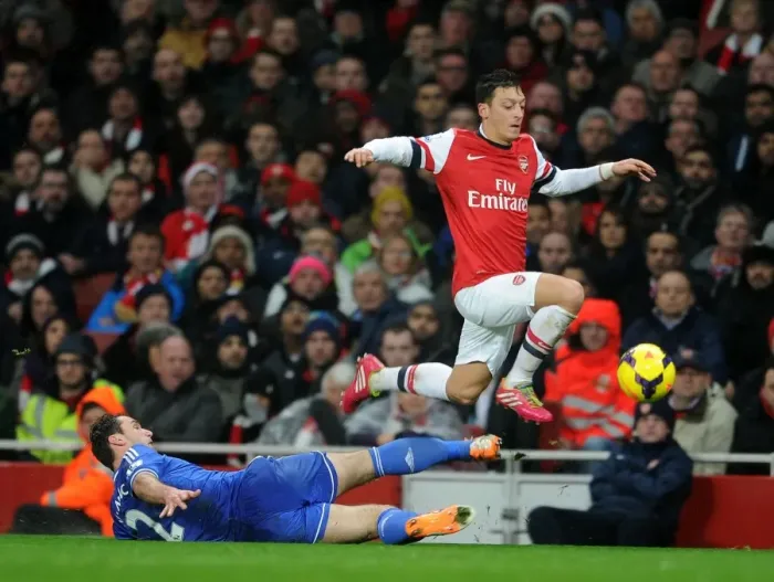 Framed Print : Mesut Ozil Evades Branislav Ivanovic: Intense Moment from the Arsenal vs Chelsea Clash (2013-14)