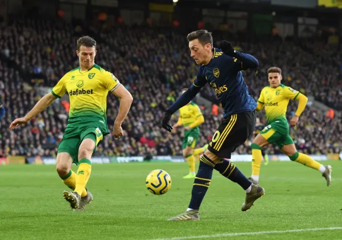 Framed Print : Mesut Ozil Evades Pressure from Christoph Zimmermann during Norwich City vs Arsenal Premier League Clash