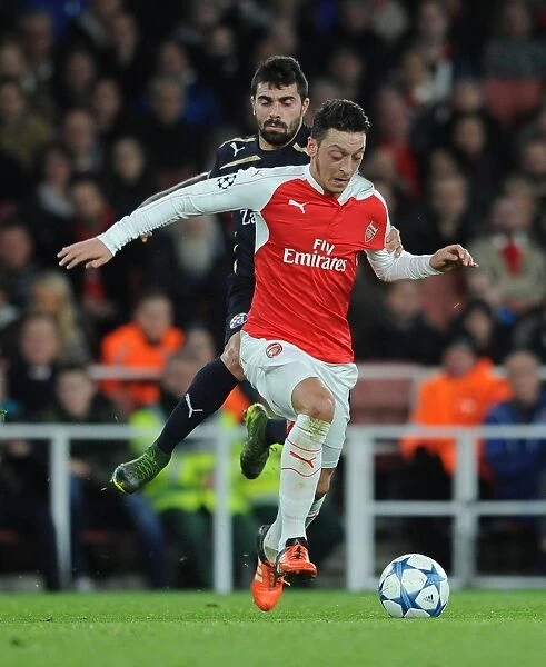 Mesut Ozil Faces Intense Pressure from Paulo Machado in Arsenal's Champions League Clash against Dinamo Zagreb