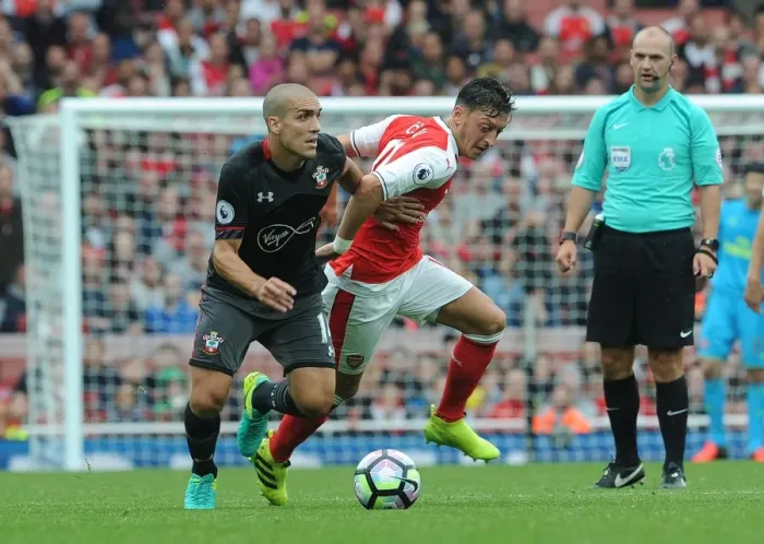 Framed Print : Mesut Ozil Faces Intense Pressure from Southampton's Oriol Romeu in Arsenal vs Southampton Clash (2016-17)