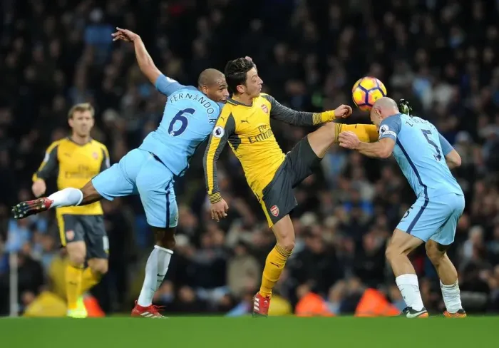 Framed Print : Mesut Ozil Faces Off Against Pablo Zabaleta and Fernando Reges in Manchester City vs Arsenal Clash