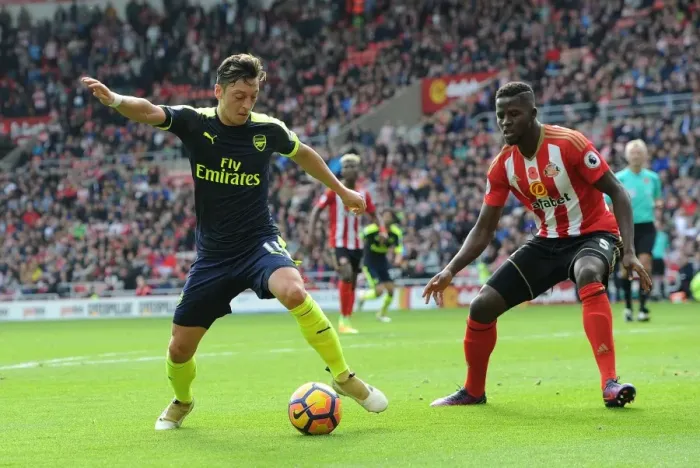 Framed Print : Mesut Ozil Faces Off Against Papy Djilobodji in Intense Sunderland vs. Arsenal Clash