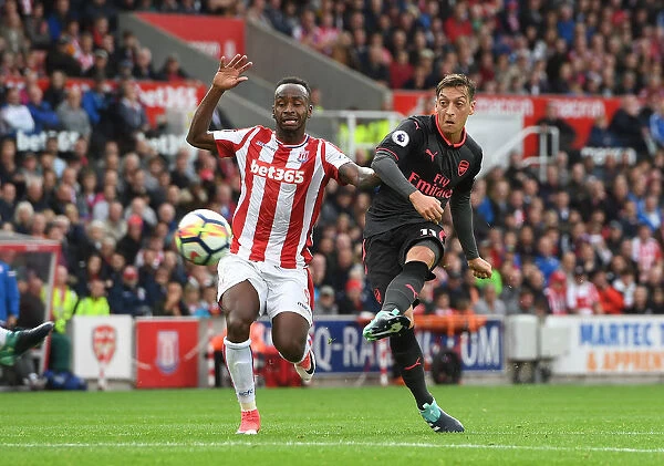 Mesut Ozil Faces Off Against Saido Berahino: A Tense Moment from Stoke City vs Arsenal (2017-18)
