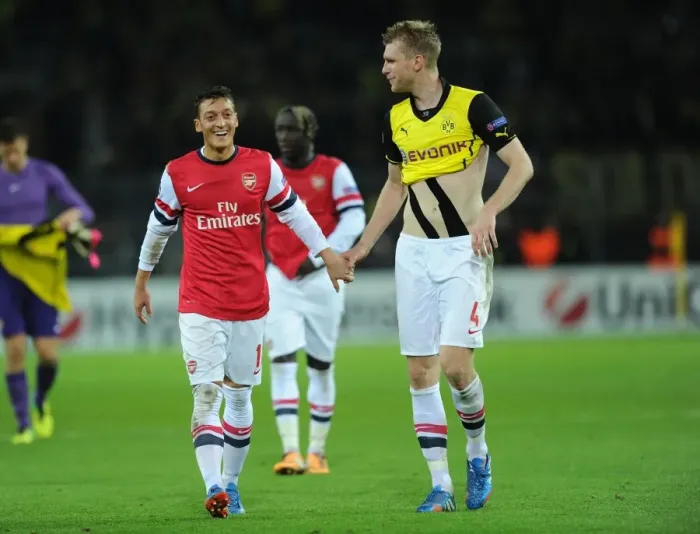 Framed Print : Mesut Ozil and Per Mertesacker Celebrate Arsenal's Victory over Borussia Dortmund in the UEFA Champions League