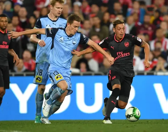 Framed Print : Mesut Ozil Outmaneuvers Brandon O'Neill: Sydney FC vs. Arsenal Pre-Season Clash