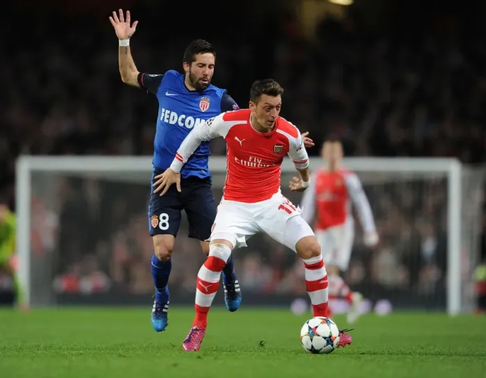 Framed Print : Mesut Ozil Outmaneuvers Joao Moutinho in Arsenal's UEFA Champions League Clash