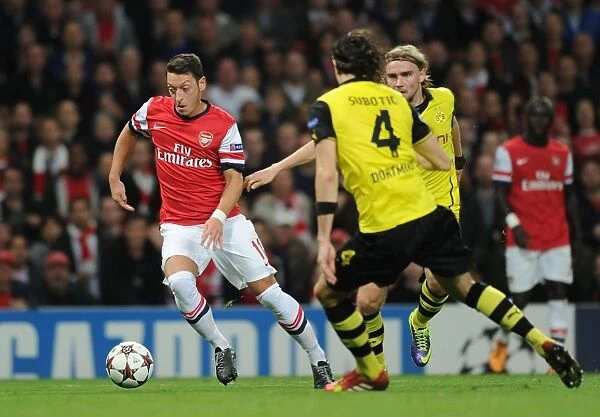 Mesut Ozil Outmaneuvers Neven Subotic and Marcel Schmelzer in Arsenal vs. Borussia Dortmund UEFA Champions League Clash