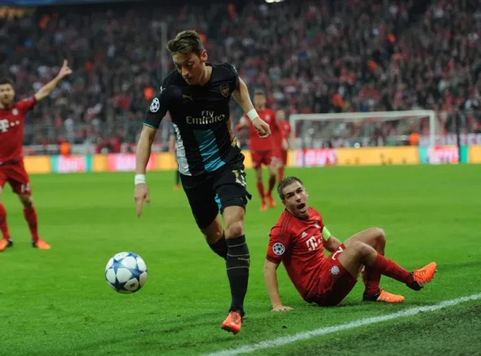 Framed Print : Mesut Ozil Outmaneuvers Phillip Lahm: A UEFA Champions League Showdown