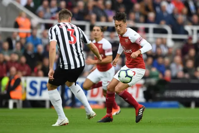 Framed Print : Mesut Ozil and Paul Dummett Clash in Intense Arsenal Victory over Newcastle United at St. James Park (1:2)