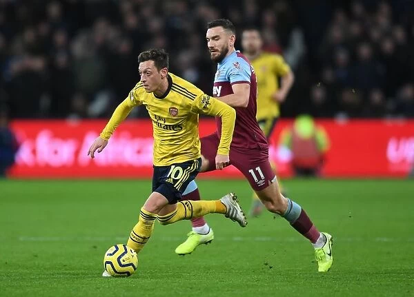Mesut Ozil Under Pressure: West Ham vs. Arsenal, Premier League 2019-20: A Battle at London Stadium