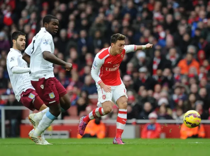 Framed Print : Mesut Ozil scores Arsenals 2nd goal under pressure from Jores Okore and Carles Gil (Villa) Framed Print : Mesut Ozil scores Arsenals 2nd goal under pressure from Jores Okore and Carles Gil (Villa)