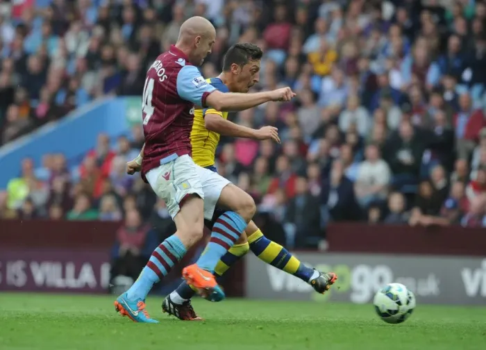 Framed Print : Mesut Ozil Scores First Arsenal Goal of the Season Against Aston Villa Amidst Philippe Senderos Pressure (2014-15) Framed Print : Mesut Ozil Scores First Arsenal Goal of the Season Against Aston Villa Amidst Philippe Senderos Pressure (2014-15)