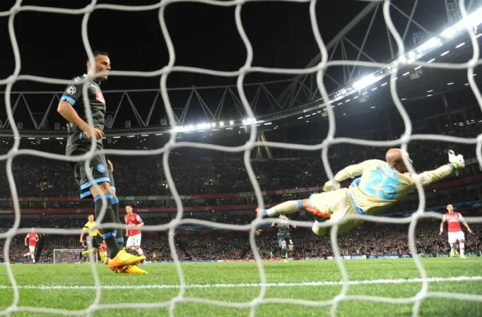 Framed Print : Mesut Ozil Scores Stunner Past Pepe Reina in Arsenal's UEFA Champions League Victory over Napoli (2013-14)