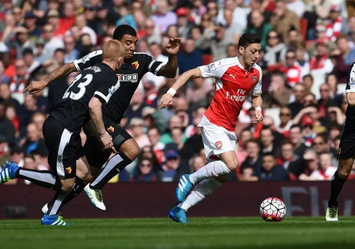 Framed Print : Mesut Ozil Slices Through Defenders: Arsenal's Triumph over Watford (April 2016) Framed Print : Mesut Ozil Slices Through Defenders: Arsenal's Triumph over Watford (April 2016)