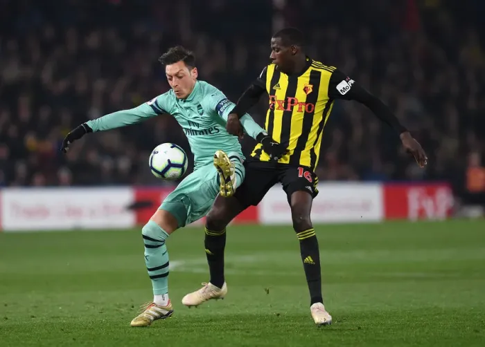 Framed Print : Mesut Ozil vs Abdoulaye Doucoure: Intense Clash in Watford v Arsenal Premier League Match, 2018-19