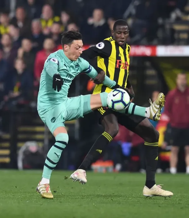 Framed Print : Mesut Ozil vs Abdoulaye Doucoure: A Premier League Showdown at Vicarage Road Framed Print : Mesut Ozil vs Abdoulaye Doucoure: A Premier League Showdown at Vicarage Road