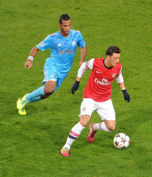 Framed Print : Mesut Ozil vs Alaixys Romao: A Football Rivalry Ignites in the Arsenal vs Marseille UEFA Champions League Clash