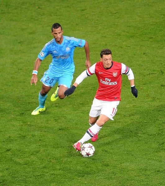 Mesut Ozil vs. Alaixys Romao: A Battle in the Arsenal v Marseille UEFA Champions League Match, 2013