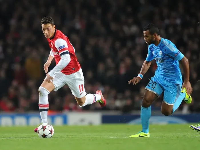 Framed Print : Mesut Ozil vs Alaixys Romao: Clash of Midfield Maestros in Arsenal vs Marseille UCL Showdown Framed Print : Mesut Ozil vs Alaixys Romao: Clash of Midfield Maestros in Arsenal vs Marseille UCL Showdown
