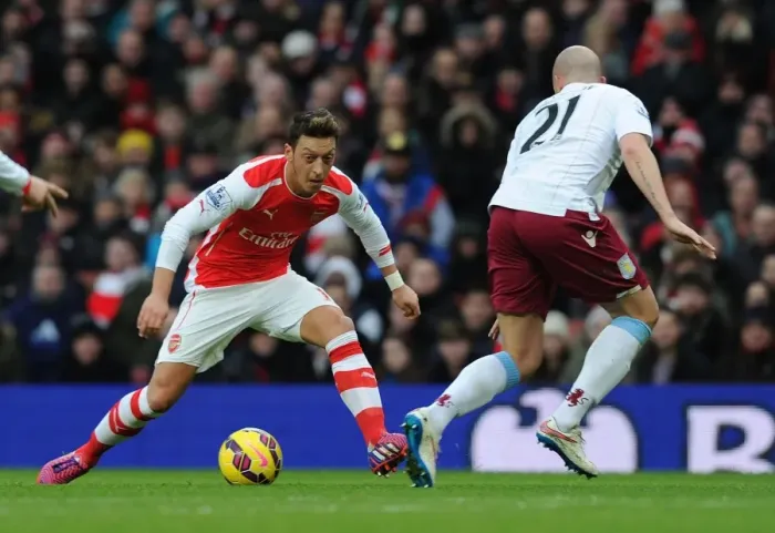 Framed Print : Mesut Ozil vs Alan Hutton: Clash at Emirates Stadium - Arsenal v Aston Villa, Premier League 2014-15