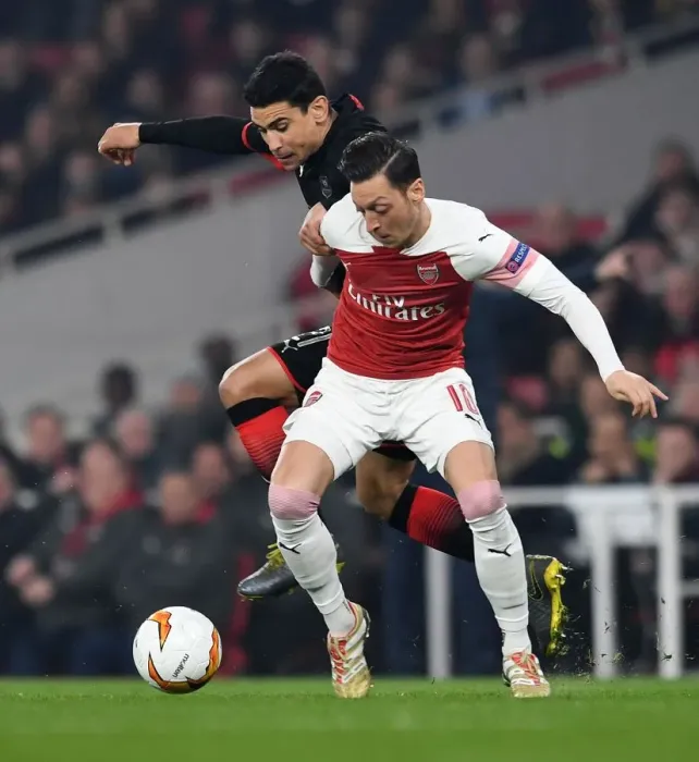 Framed Print : Mesut Ozil vs Benjamin Andre: A Battle in the Arsenal v Stade Rennais UEFA Europa League Clash