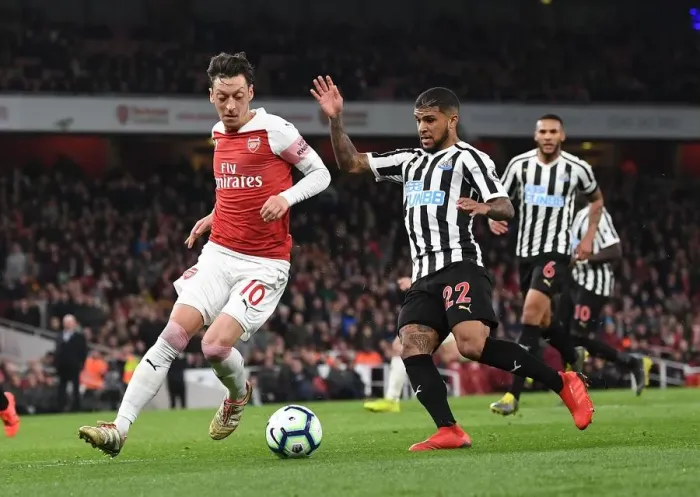 Framed Print : Mesut Ozil vs DeAndre Yedlin: Intense Battle at Arsenal's Emirates Stadium