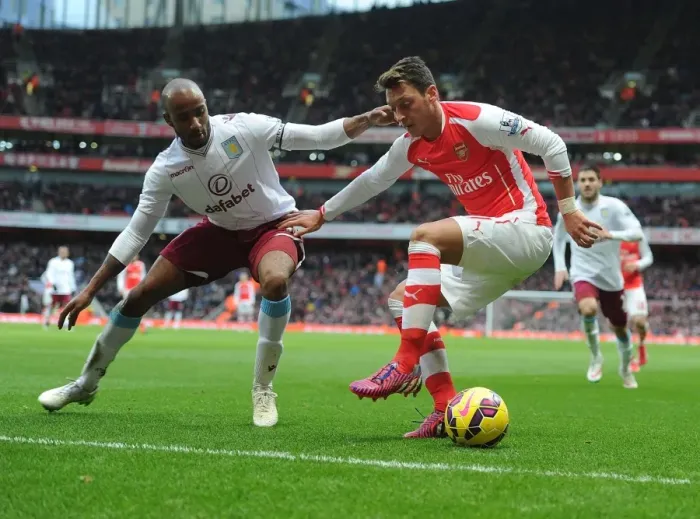 Framed Print : Mesut Ozil vs Fabian Delph: A Battle at Emirates Stadium (Arsenal v Aston Villa, 2014-15)