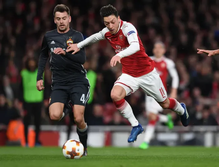 Framed Print : Mesut Ozil vs. Georgi Schennikov: A Battle in the Arsenal FC vs. CSKA Moskva UEFA Europa League Quarterfinal