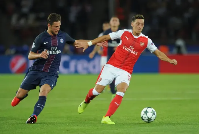 Framed Print : Mesut Ozil vs. Grzegorz Krychowiak: A Champions League Battle at Parc des Princes, 2016