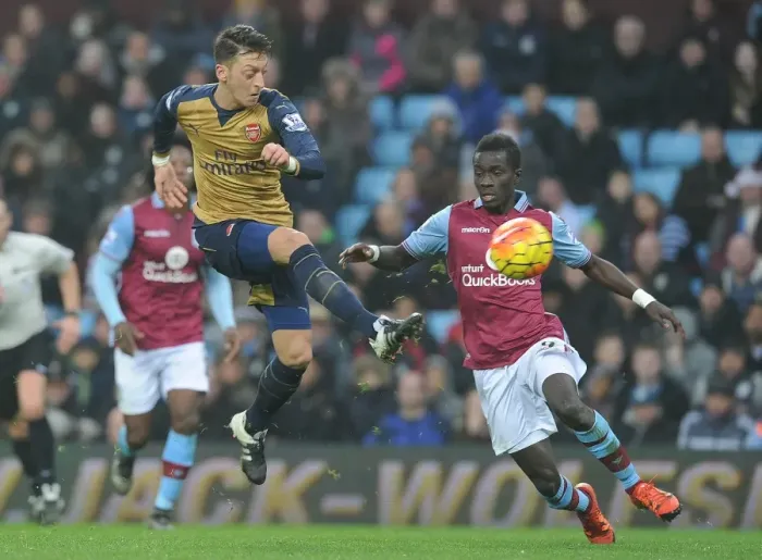 Framed Print : Mesut Ozil vs. Idrissa Gana: A Premier League Showdown at Villa Park