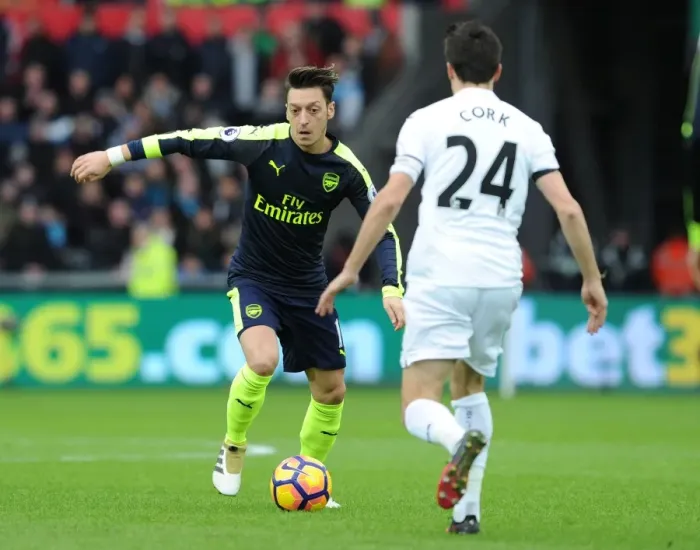 Framed Print : Mesut Ozil vs Jack Cork: A Premier League Showdown at Swansea City
