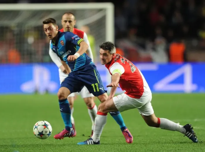 Framed Print : Mesut Ozil vs. Jeremy Toulalan: Battle for Ball Possession in Monaco vs. Arsenal, UEFA Champions League 2015