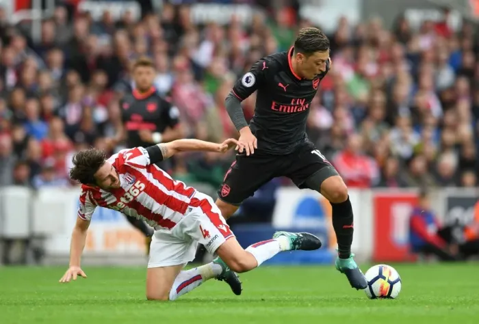 Framed Print : Mesut Ozil vs Joe Allen: A Premier League Battle at Stoke City