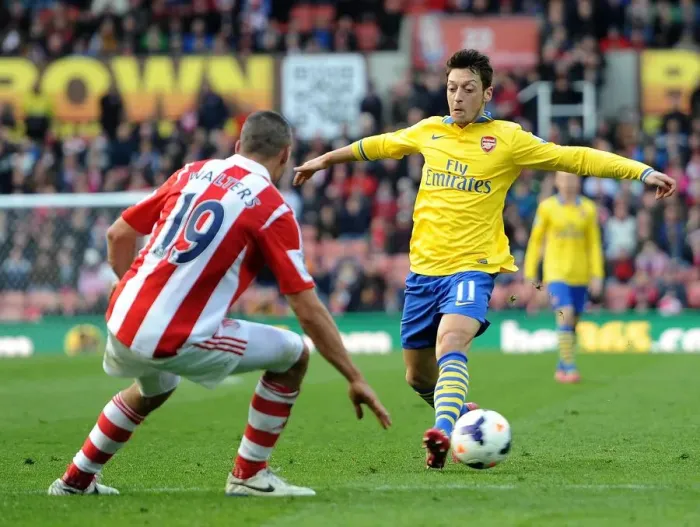 Framed Print : Mesut Ozil vs. Jonathan Walters: Clash at Britannia Stadium - Stoke City vs. Arsenal, Premier League 2013-14