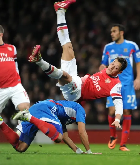 Framed Print : Mesut Ozil vs. Liam Rosenior: A Tenacious Clash at Arsenal's Emirates Stadium (Arsenal vs. Hull City, 2013-14)