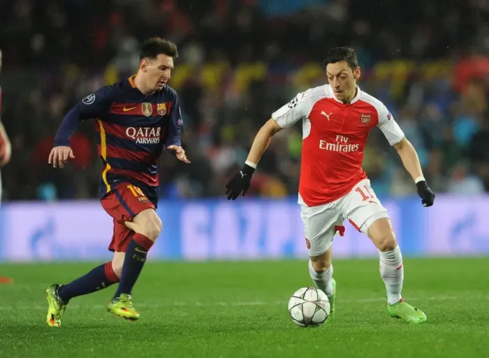 Framed Print : Mesut Ozil vs. Lionel Messi: A Champions League Battle