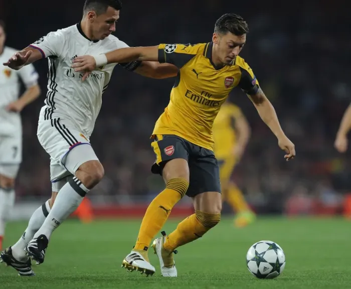 Framed Print : Mesut Ozil vs Marek Suchy: A Fierce Battle in Arsenal's Champions League Showdown