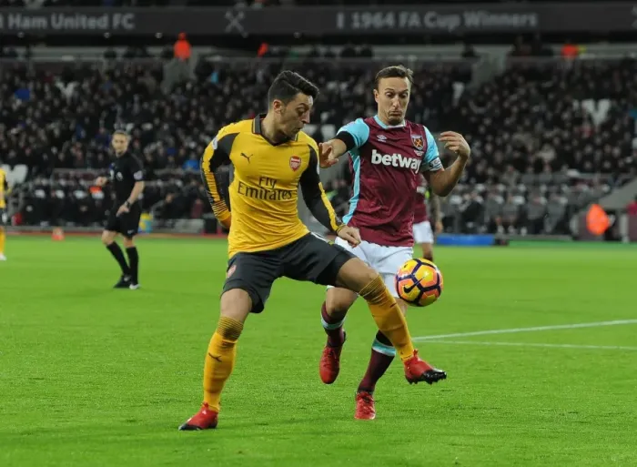 Framed Print : Mesut Ozil vs Mark Noble: Intense Battle in West Ham United vs Arsenal Premier League Clash Framed Print : Mesut Ozil vs Mark Noble: Intense Battle in West Ham United vs Arsenal Premier League Clash