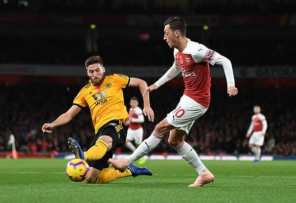 Mesut Ozil vs. Matt Doherty: Intense Clash Between Arsenal's Ozil and Wolverhampton's Doherty in Premier League Match