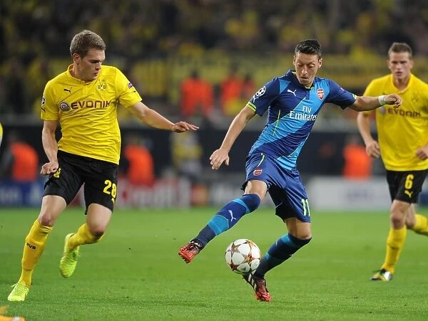 Mesut Ozil vs. Matthias Ginter: Intense Battle in Borussia Dortmund vs. Arsenal UEFA Champions League Clash