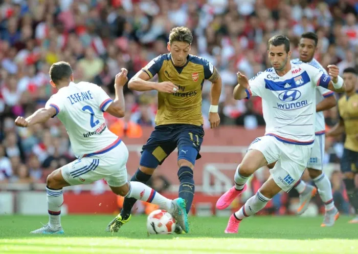 Framed Print : Mesut Ozil vs. Mehdi Zeffane & Maxime Gonalons: Intense Face-Off at Arsenal vs. Olympique Lyonnais (Emirates Cup 2015 / 16) Framed Print : Mesut Ozil vs. Mehdi Zeffane & Maxime Gonalons: Intense Face-Off at Arsenal vs. Olympique Lyonnais (Emirates Cup 2015 / 16)