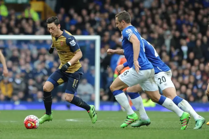 Framed Print : Mesut Ozil vs. Phil Jagielka: A Premier League Showdown at Goodison Park
