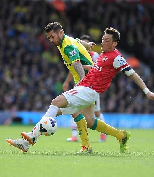 Mesut Ozil vs. Robert Snodgrass: Intense Battle at Carrow Road - Norwich City vs. Arsenal (2013-14)
