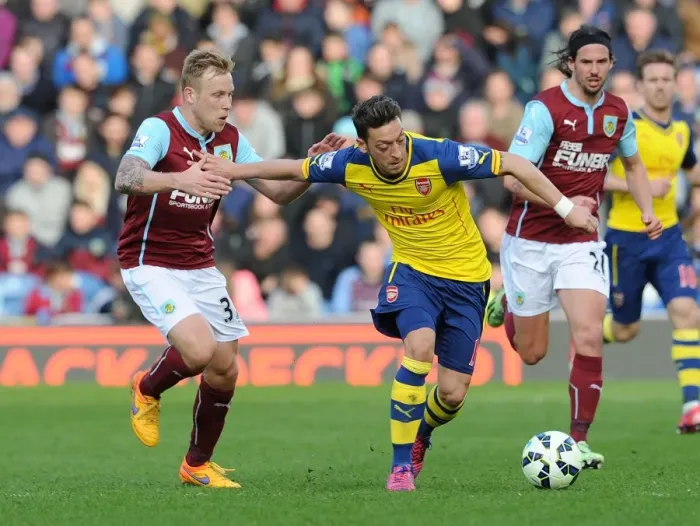 Framed Print : Mesut Ozil vs. Scott Arfield: A Premier League Showdown at Turf Moor