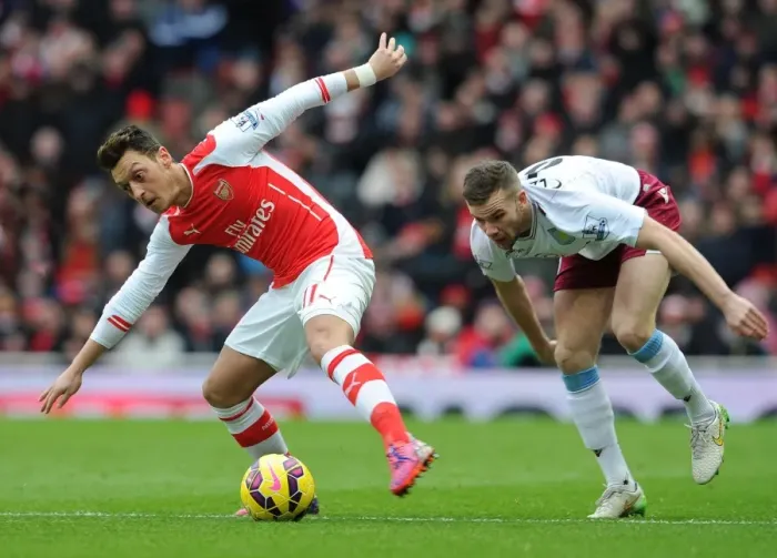 Framed Print : Mesut Ozil vs. Tom Cleverley: Intense Battle at the Emirates, Arsenal vs. Aston Villa, Premier League