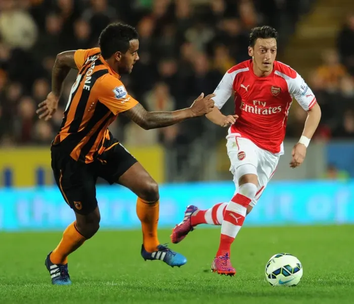 Framed Print : Mesut Ozil vs. Tom Huddlestone: A Premier League Battle at Hull City (2014 / 15) Framed Print : Mesut Ozil vs. Tom Huddlestone: A Premier League Battle at Hull City (2014 / 15)