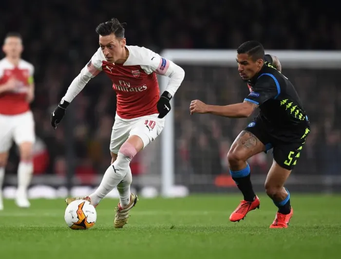 Framed Print : Mesut Ozil's Magic: Outsmarting Napoli's Allan in Arsenal's Europa League Victory