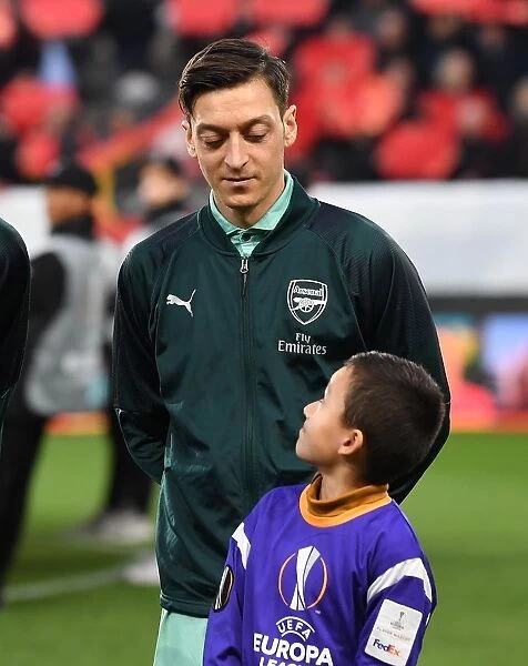 Mesut Ozil's Welcome: Arsenal Players Escorted at Stade Rennais, UEFA Europa League Round of 16 (First Leg)