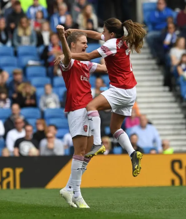 Framed Print : Miedema and van de Donk Celebrate Arsenal's Winning Goal vs. Brighton Women